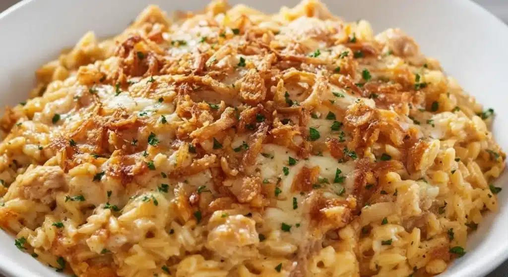 Creamy French onion chicken orzo casserole topped with bubbly Gruyere