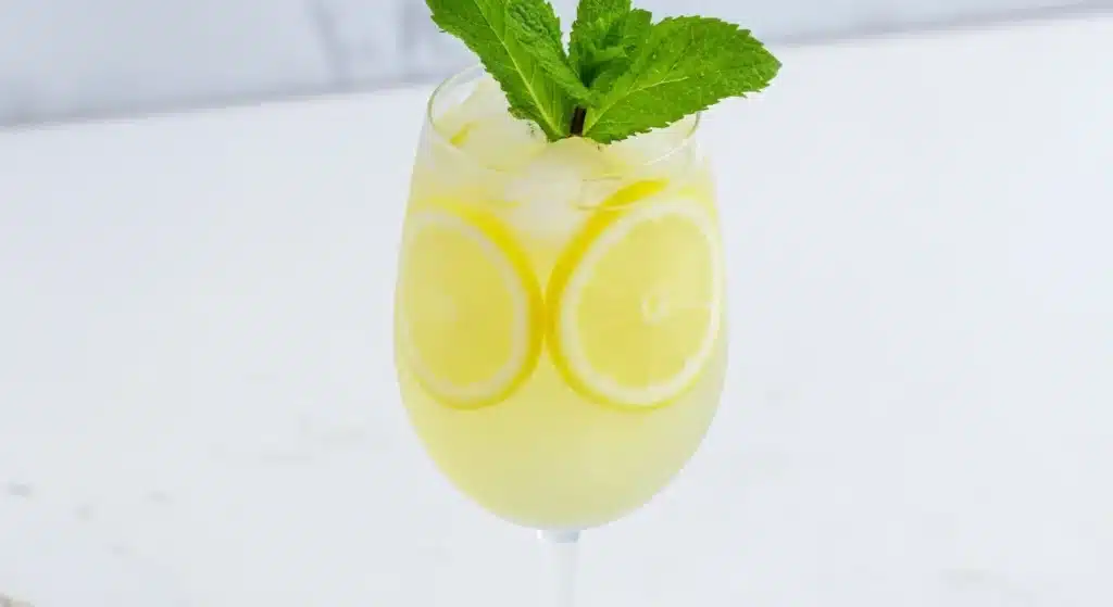 Refreshing Italian Limoncello Spritz with lemon slice and mint garnish
