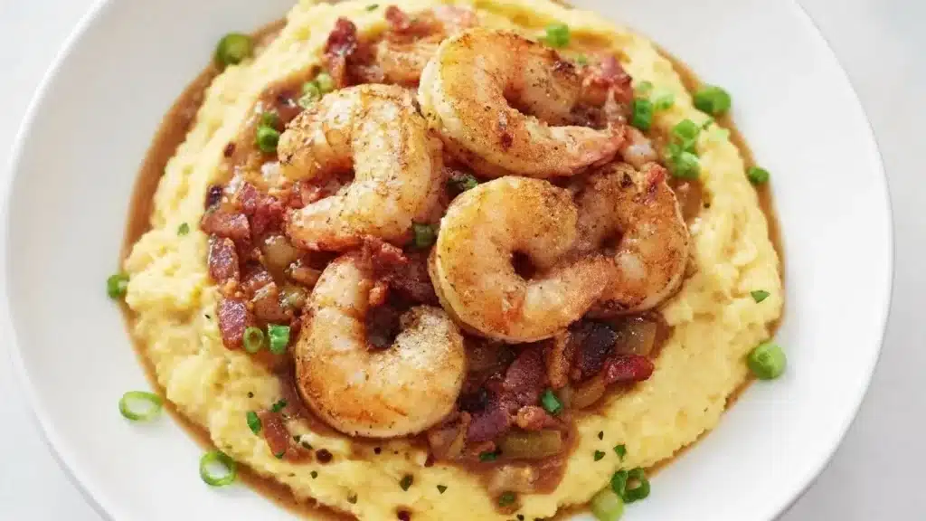 Bowl of Classic Shrimp and Grits topped with bacon and parsley